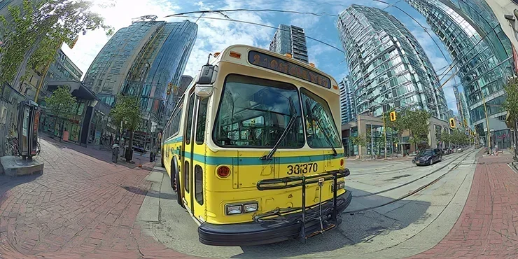 a three quarter fish eye view of a yellow city bus